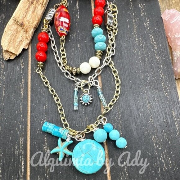 Layered multi charm necklace with turquoise and tassel